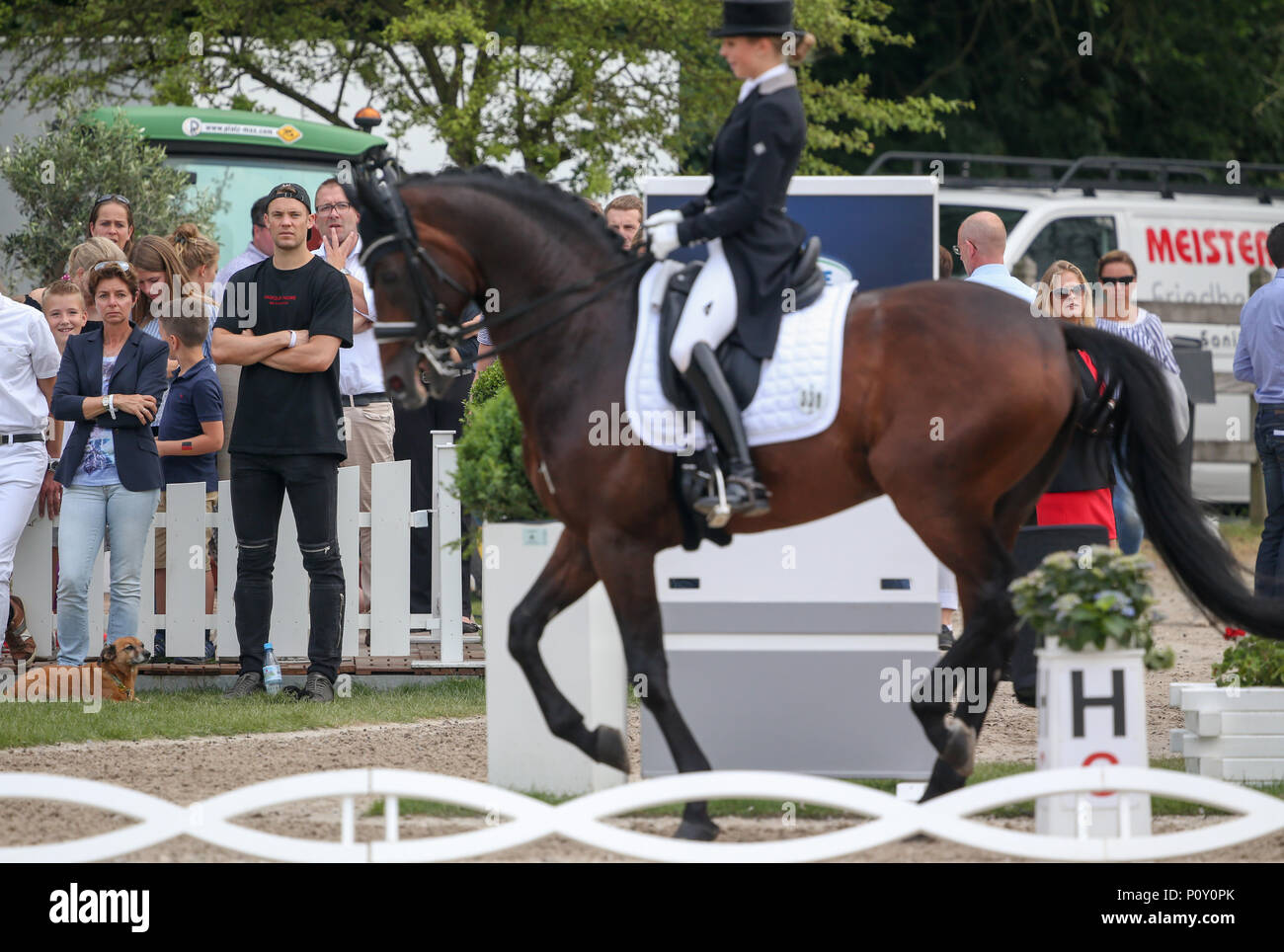 10 June 2018, Balve, Germany: Monica Theodorescu, federal trainer for dressage riding and soccer national goalkeeper Manuel Neuer (C) watch the performance of Neuer's wife Nina Neuer, who is competing in the Grand Prix U25 with horse Don Darius. Photo: Friso Gentsch/dpa Stock Photo