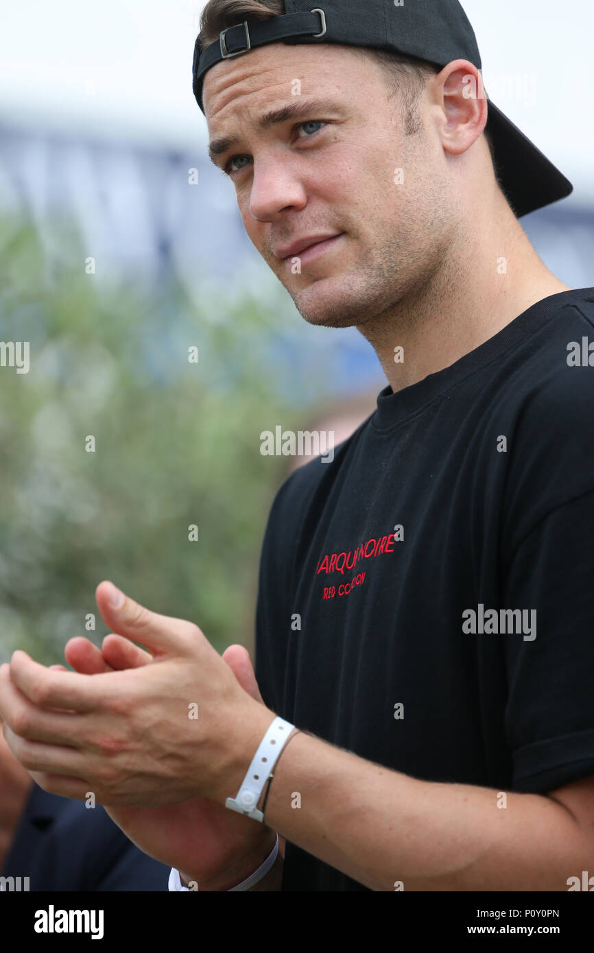 10 June 2018, Balve, Germany: Soccer national goalkeeper Manuel Neuer watches the performance of his wife Nina Neuer, who is competing in the Grand Prix U25 with horse Don Darius. Photo: Friso Gentsch/dpa Stock Photo