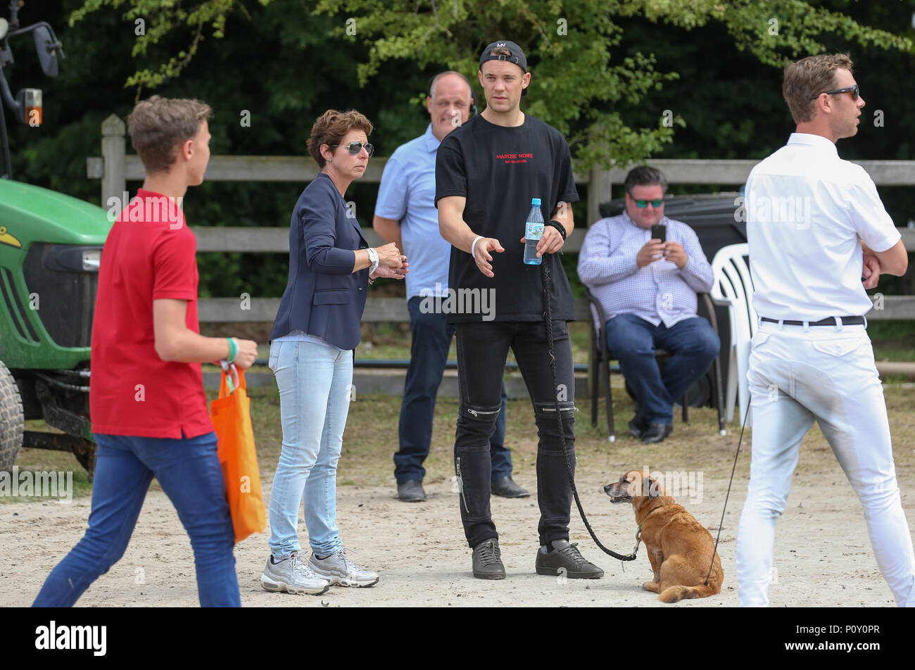 10 June 2018, Balve, Germany: Monica Theodorescu, federal trainer for dressage riding and soccer national goalkeeper Manuel Neuer (C) watch the performance of Neuer's wife Nina Neuer, who is competing in the Grand Prix U25 with horse Don Darius. Photo: Friso Gentsch/dpa Stock Photo