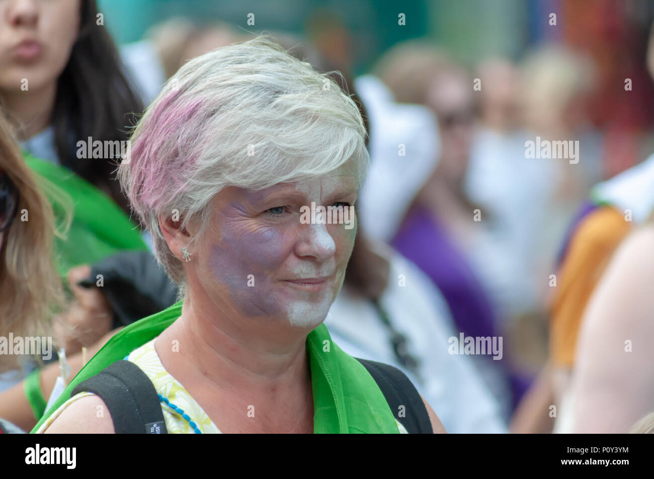 Edinburgh, Scotland, UK. 10th June, 2018. A woman with a painted face wearing a green scarf during the Edinburgh Processions Artwork march celebrating 100 years since British women won the right to vote. Thousands of women came together in the four capitals of the UK,  Belfast, Cardiff, Edinburgh and London. The Participants wore either a green, white or violet scarf and walked in stripes through the city streets to depict the colours of the suffragettes. Credit: Skully/Alamy Live News Stock Photo