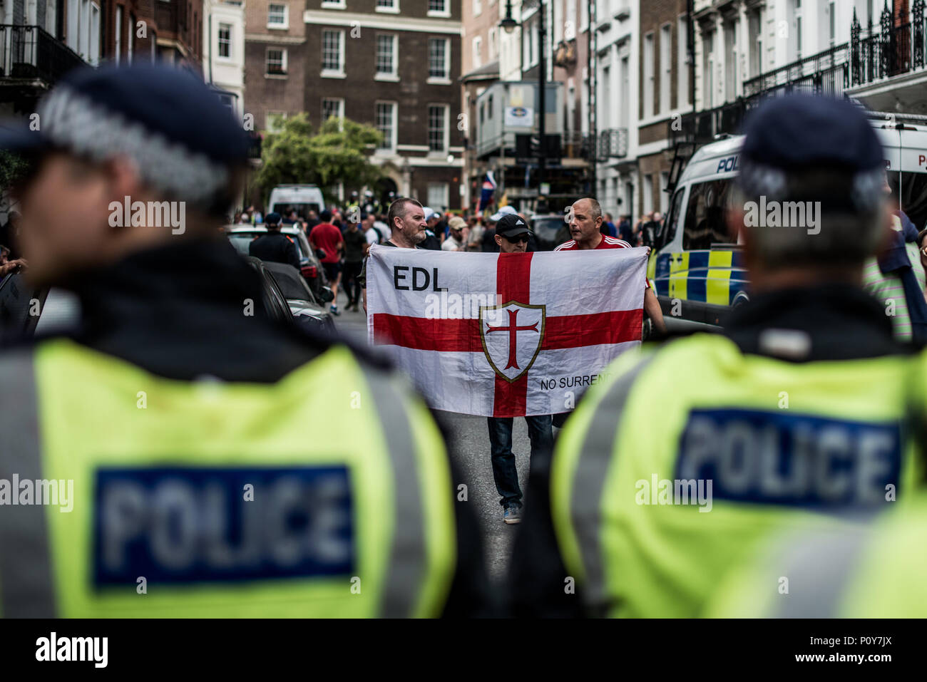 An EDL (English Defense League, far right  group) supporter seen holding an EDL flag in the counter-demo.  Hundreds of anti-Israel protesters marched through the streets on the annual Al Quds Day. Started by the Ayatollah Khomeini in 1979 to show support for Palestine and oppose the existence of Israel and the counter protest from the Zionist Federation. Stock Photo