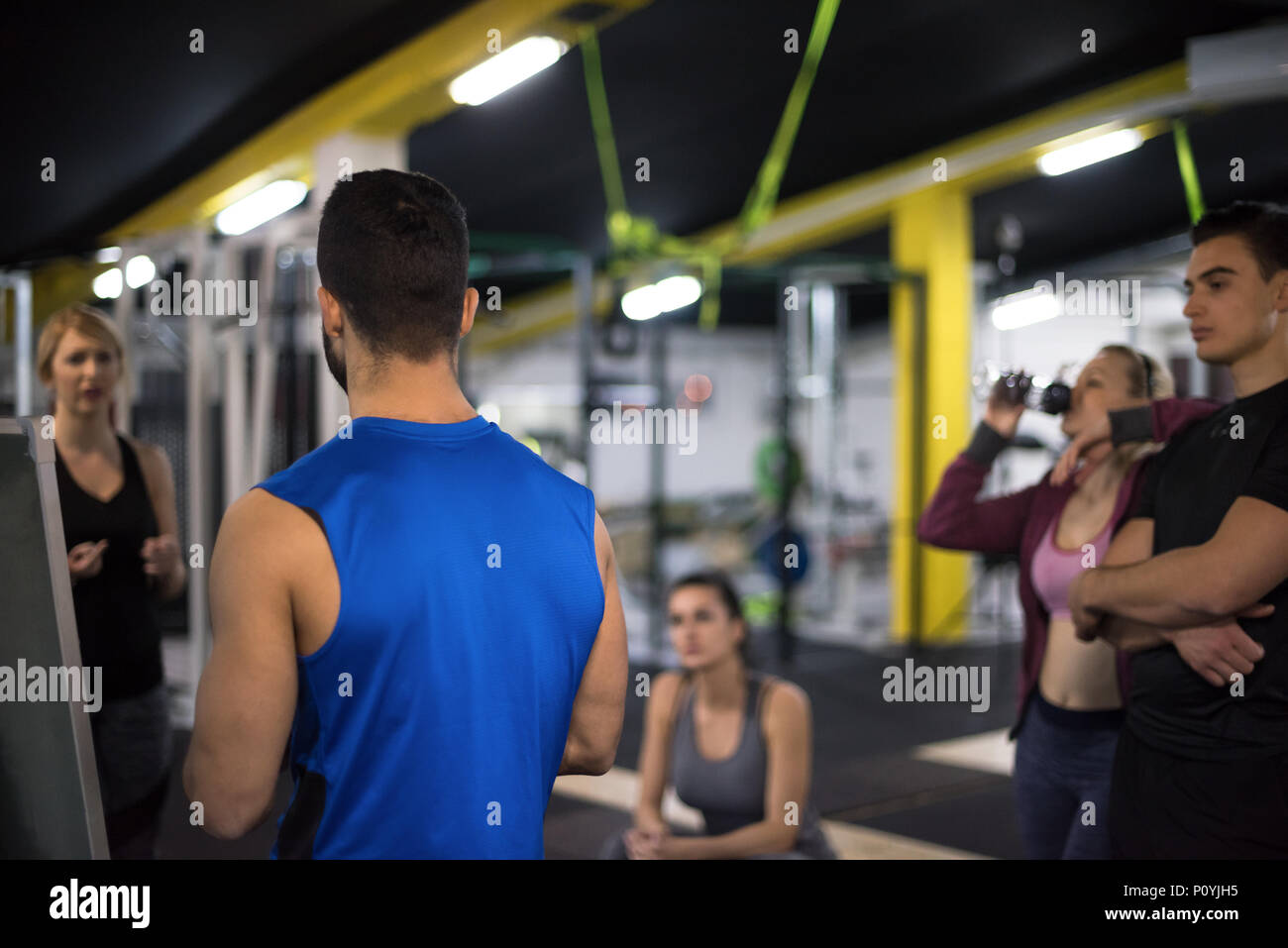 Training course.group of young athletes getting instructions from ...