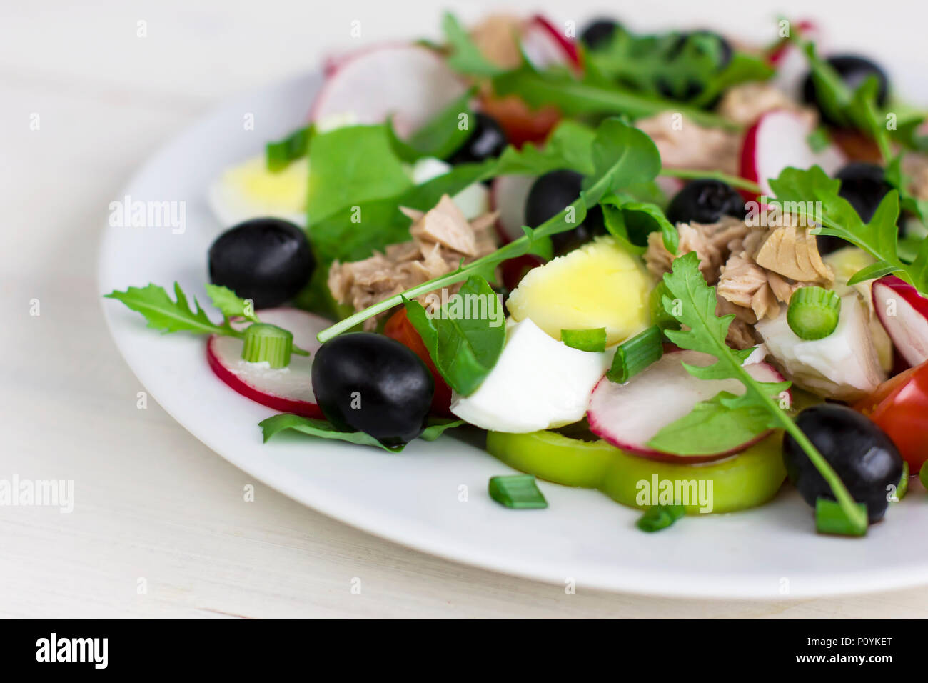 Nicoise salad with tuna, egg, cherry tomatoes and black olives. French