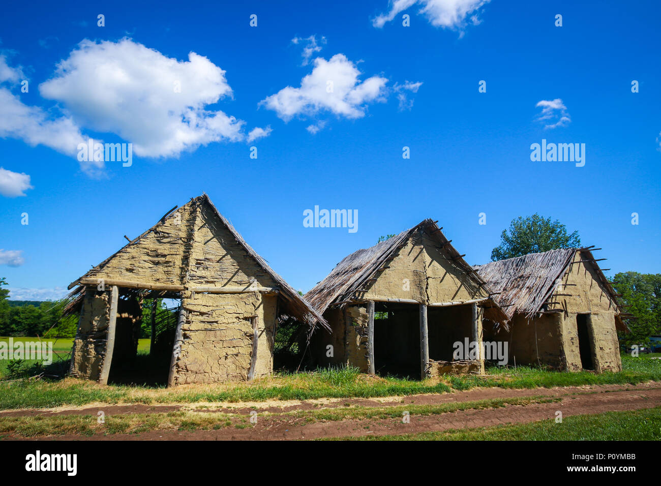 A view of the old houses with a pathway passing next to them in the archeological ethnological park Sopot in Vinkovci, Croatia. Stock Photo