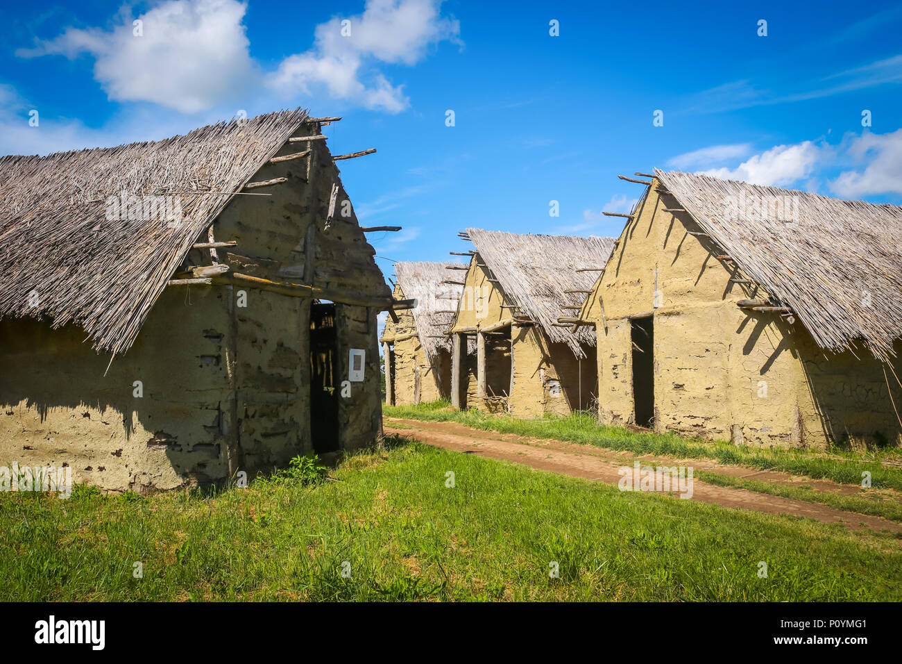 A view of the old houses with a pathway in the archeological ethnological park Sopot in Vinkovci, Croatia. Stock Photo