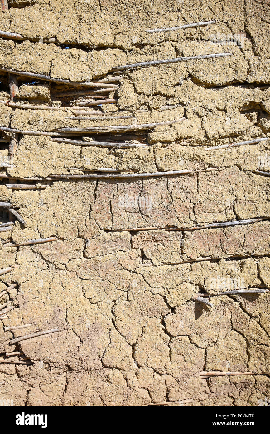 Detail of the wall traditional made of mud mixed with dry wood branches