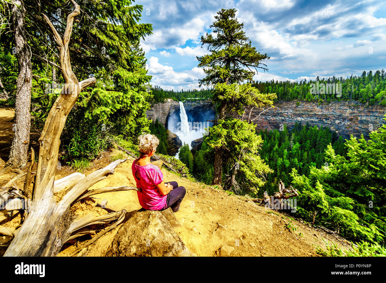 Senior woman looking at the famous and spectacular Helmcken Falls in