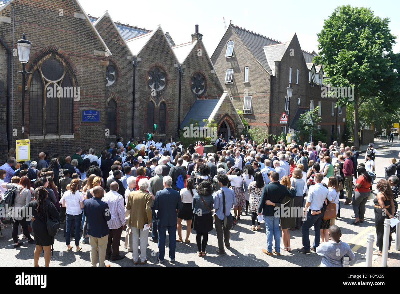 Crowds gather to attend the dedication of a new memorial garden at St Clement's Church, Notting Dale, west London to mark the first anniversary of Grenfell disaster. Stock Photo