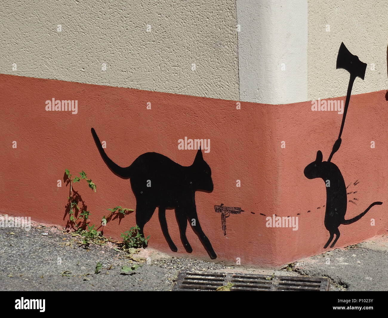 Fun And Ironic Drawings On A Side Wall In A Small Town Of A Cat And Mouse War Game Stock Photo Alamy