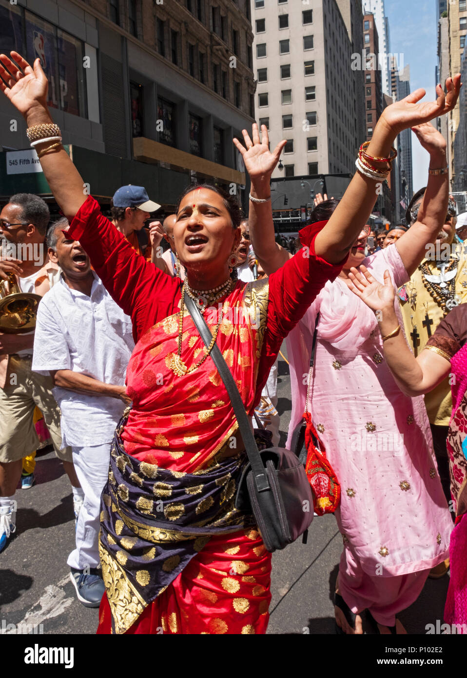 A woman in a colorful sari chanting at the Rathayatra chariot festival and parade in Midtown Manhattan, New York City. Stock Photo