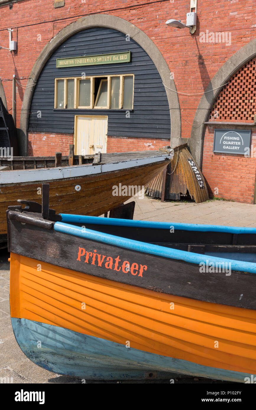 old fashioned or vintage wooden fishing boats on the beach at brighon in front of the brighton