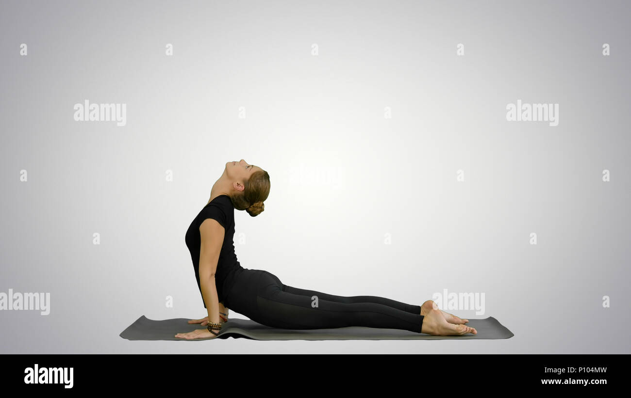 Woman doing Upward Dog Yoga Position, part of Sun Salutation on Woman doing Upward Dog Yoga Position, part of Sun Salutation on