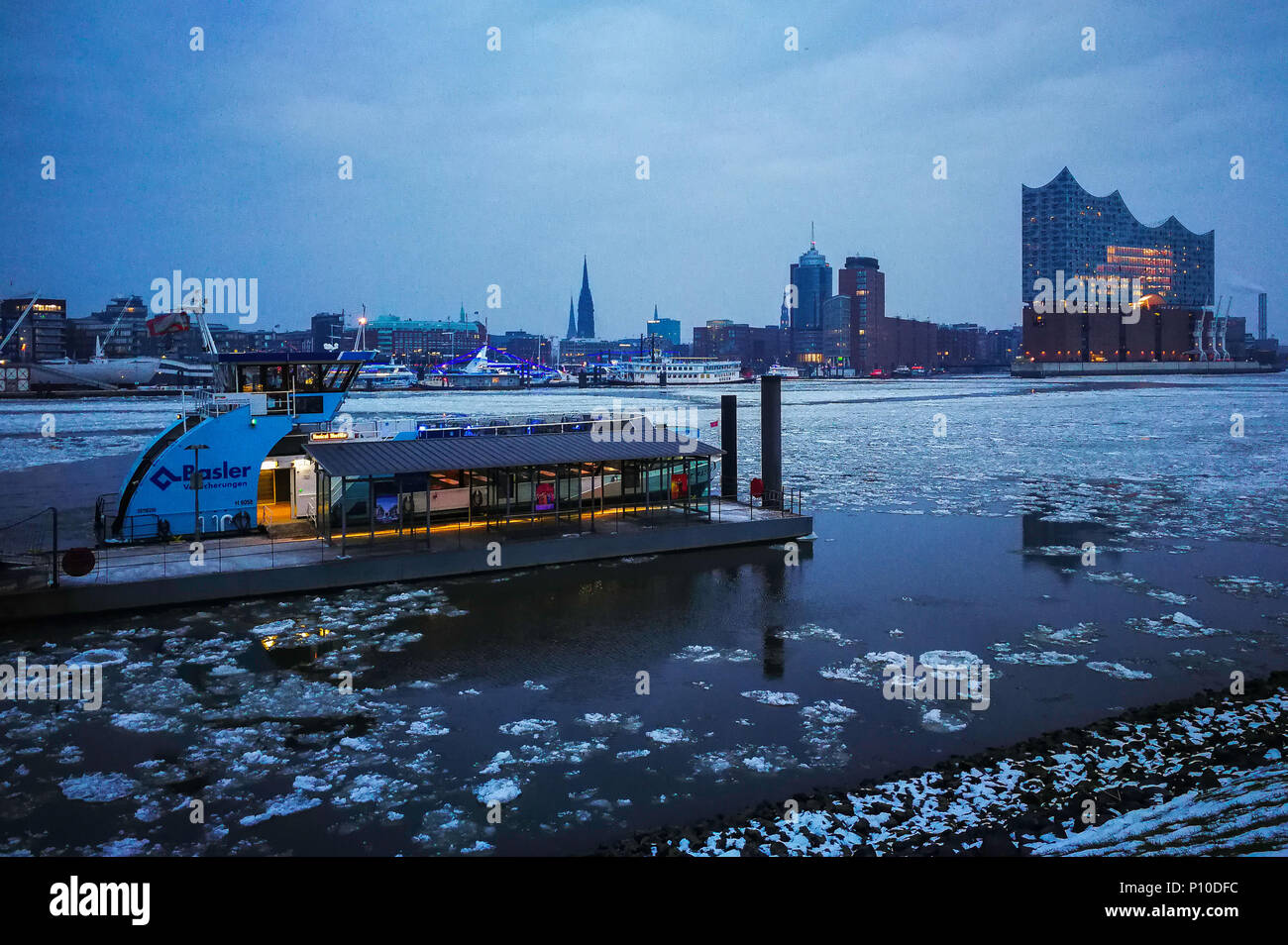 Elbe river under ice, ferry boats, Elbphilharmonie, Hamburg, Germany Stock Photo
