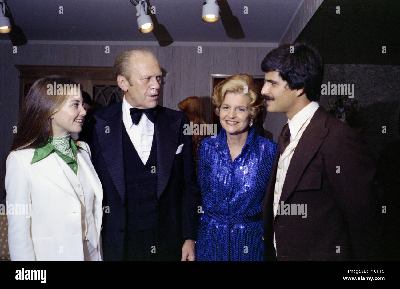 1976, October 7 – Beverly Hilton Hotel - President's Suite – Beverly Hills, CA – Gerald R. Ford, Betty Ford, Mark Spitz, Suzy Spitz – standing, talking, posing; formal wear – Presentation of the Presidential Medal of Freedom to Jesse Owens Ceremony - US Olympic Committee Stock Photo
