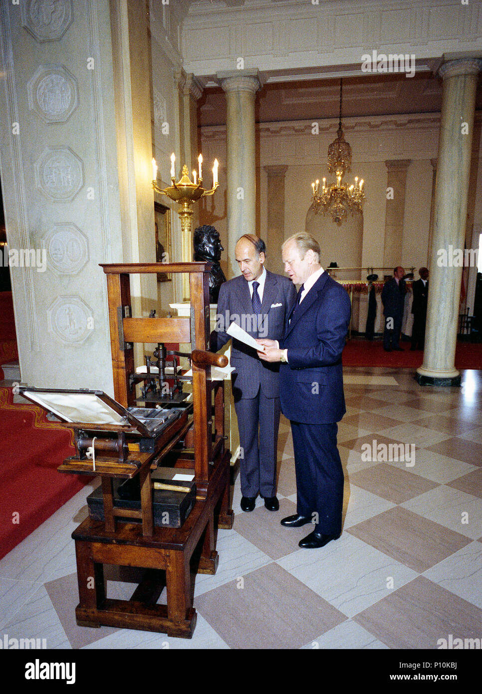 1976, May 17 –  The White House; –  Gerald R. Ford; Valery Giscard d'Estaing – standing; examining an antique printing press presented as a Bicentennial gift on behalf of the people of France – State Visit of French President Valery Giscard d'Estaing-State Gift; Bicentennial Stock Photo
