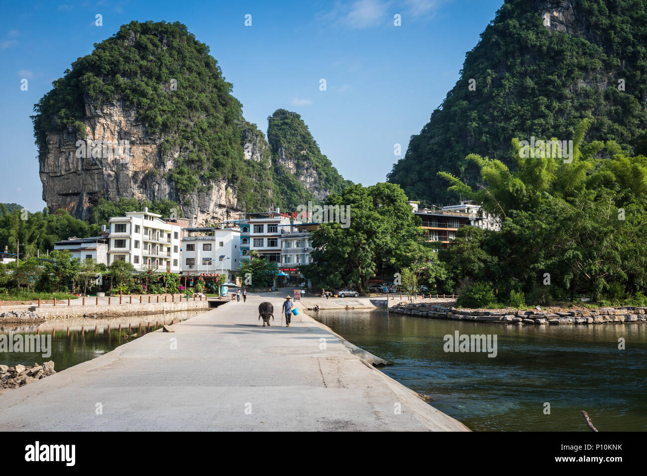 Scenic summer sunny landscape at Yangshuo County of Guilin, China. View of beautiful karst mountains Amazing green hills on blue sky background. Stock Photo