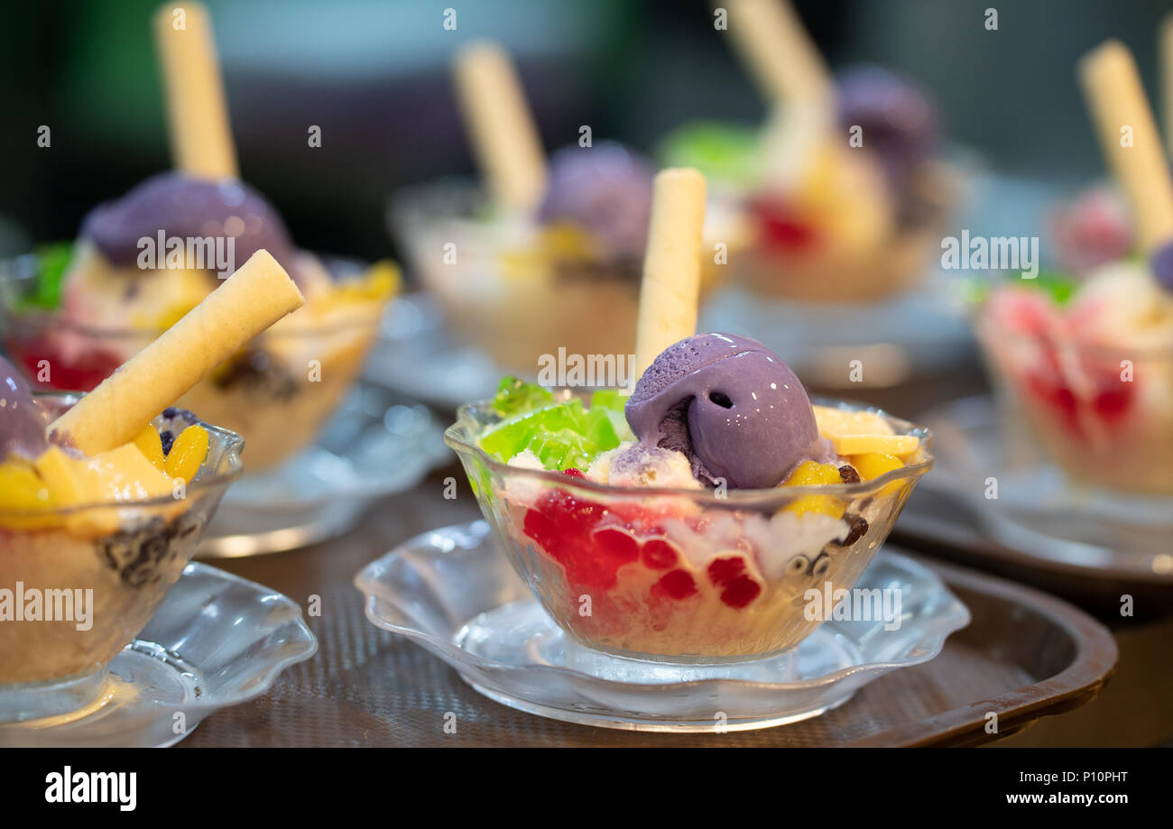 Halo Halo is a favourite Filipino dessert.A Concoction of ice shavings, evaporated milk, boiled sweetened kidney beans, sugar palm fruit, macapuno, la Stock Photo