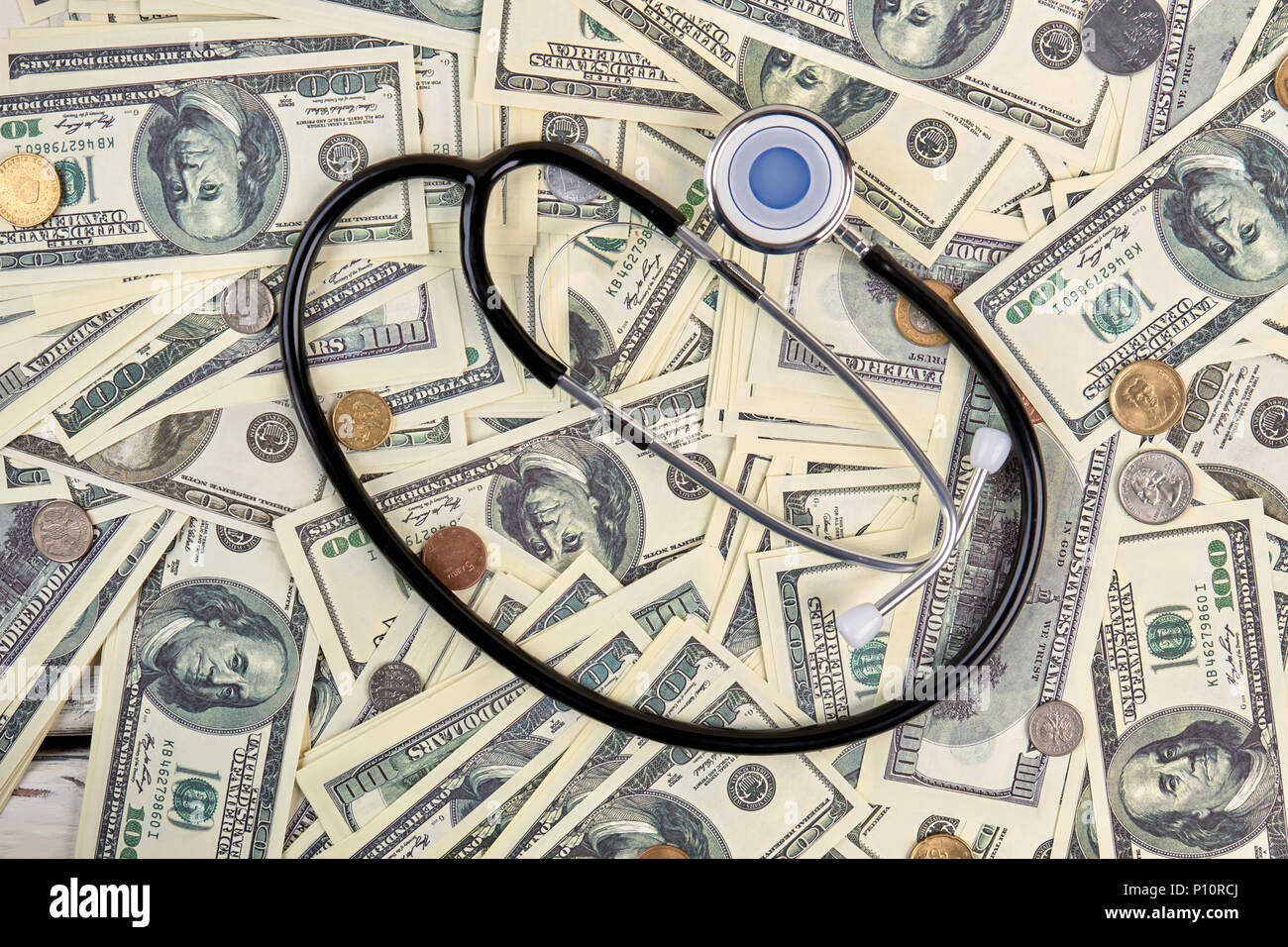 Pile of money and stethoscope. Flat lay, top view. Stock Photo