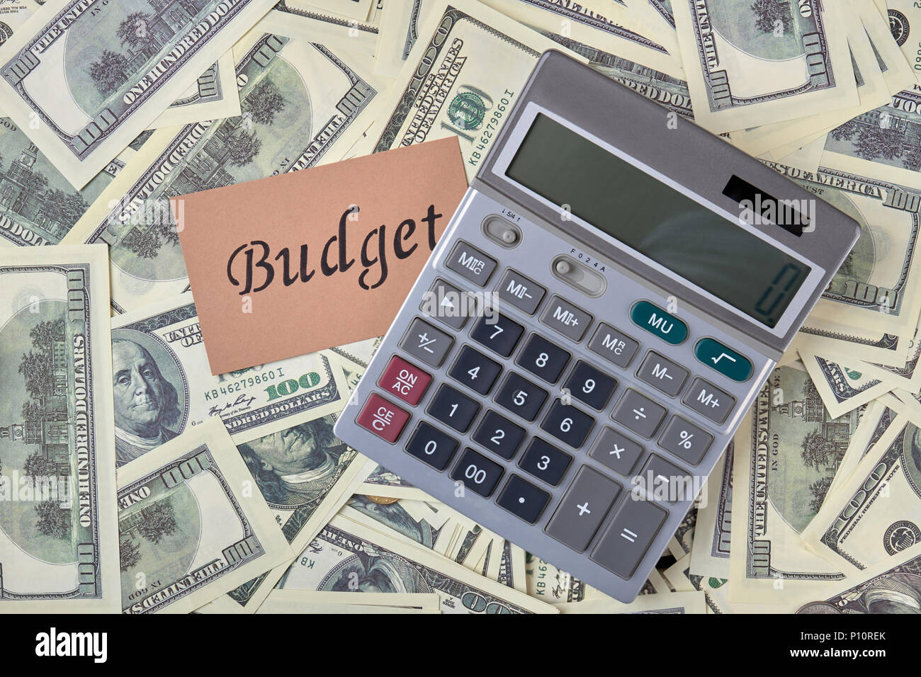 calculator and pile of money dollars budget and account budget money calculator