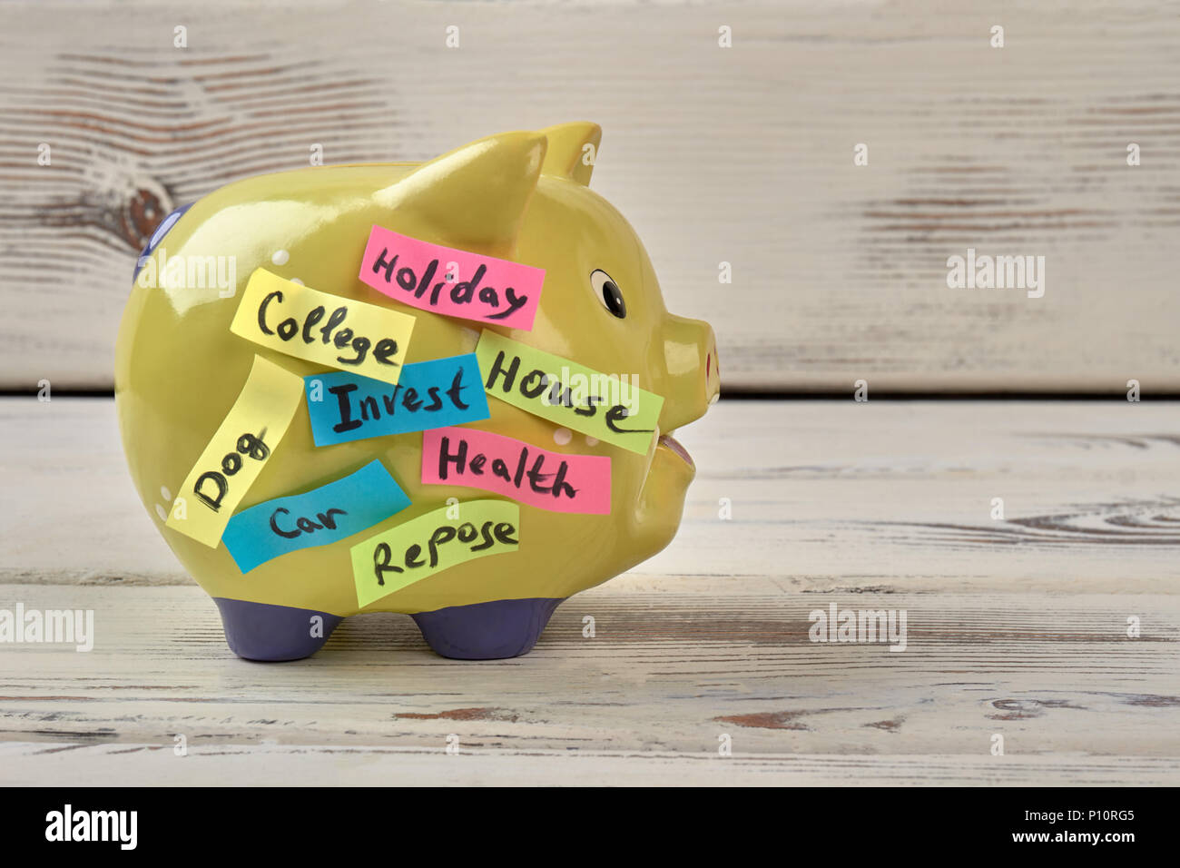 Yellow pig moneybox. White wood background. Stock Photo