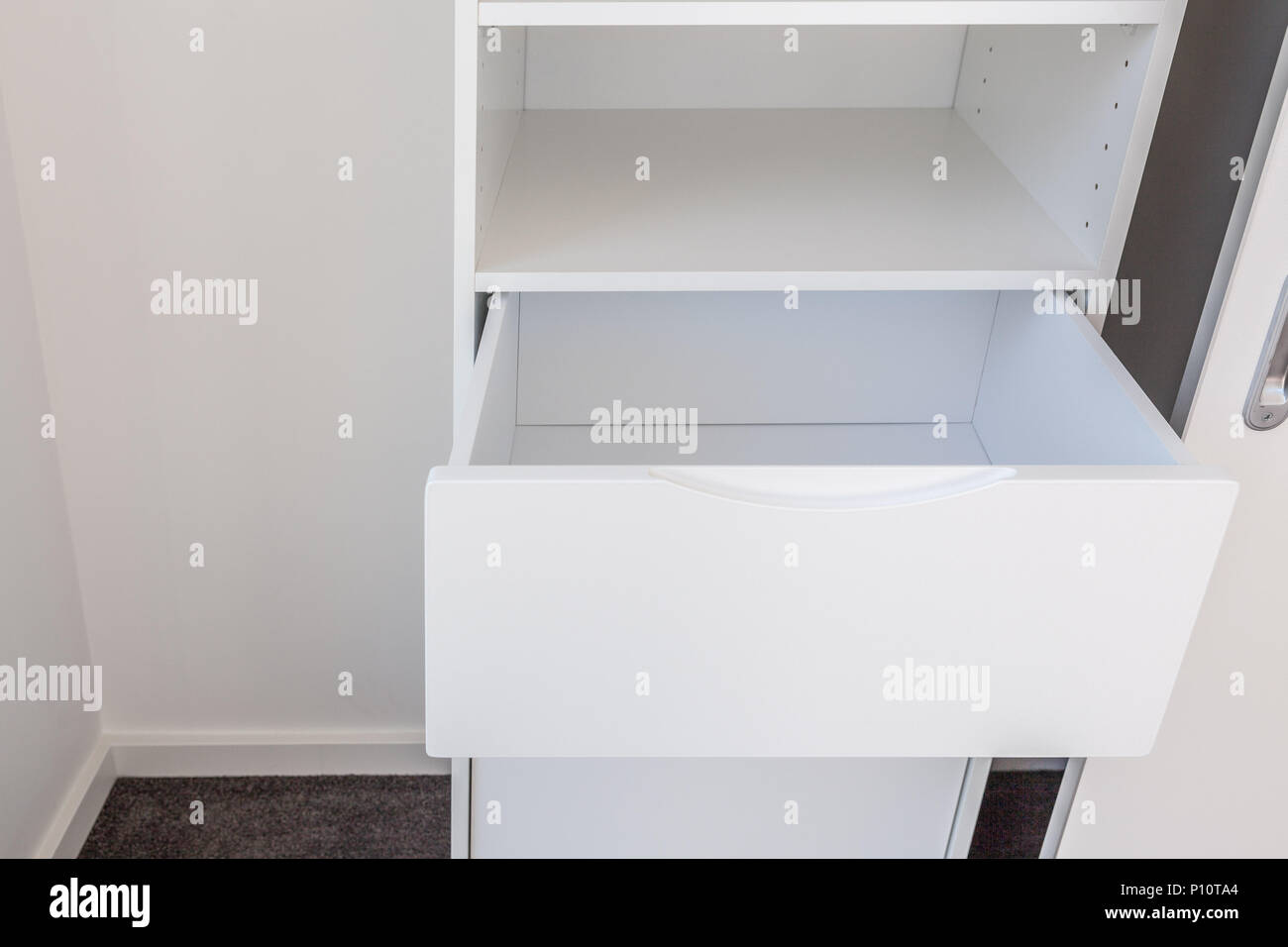 Open drawer in white cupboard Stock Photo Alamy