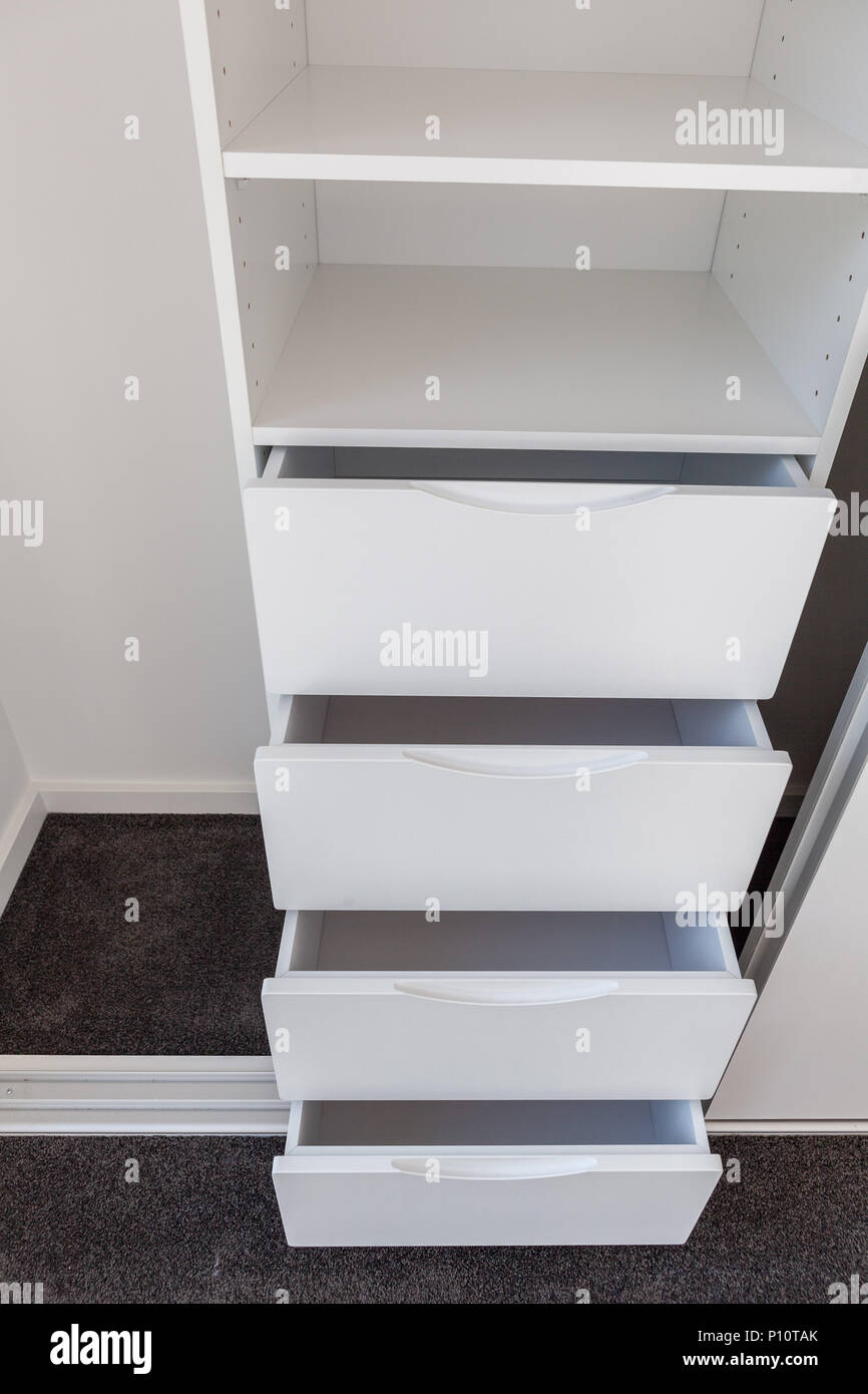 Set of open drawers in a white cupboard Stock Photo Alamy