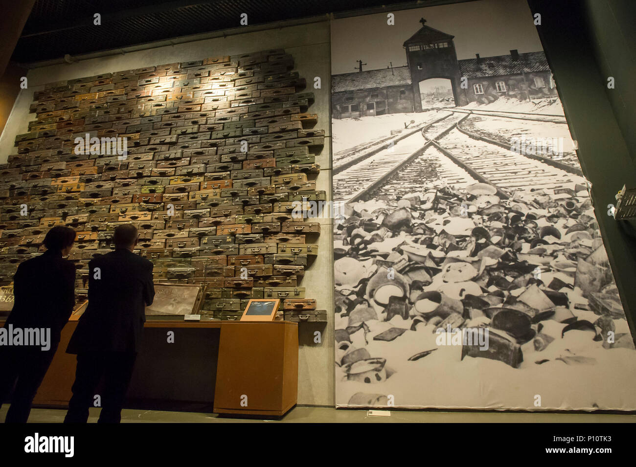 Suitcases of Jewish victims of Holocaust and picture of the main entrance to KL Auschwitz Birkenau as a part of exhibion in Museum of the Second World Stock Photo