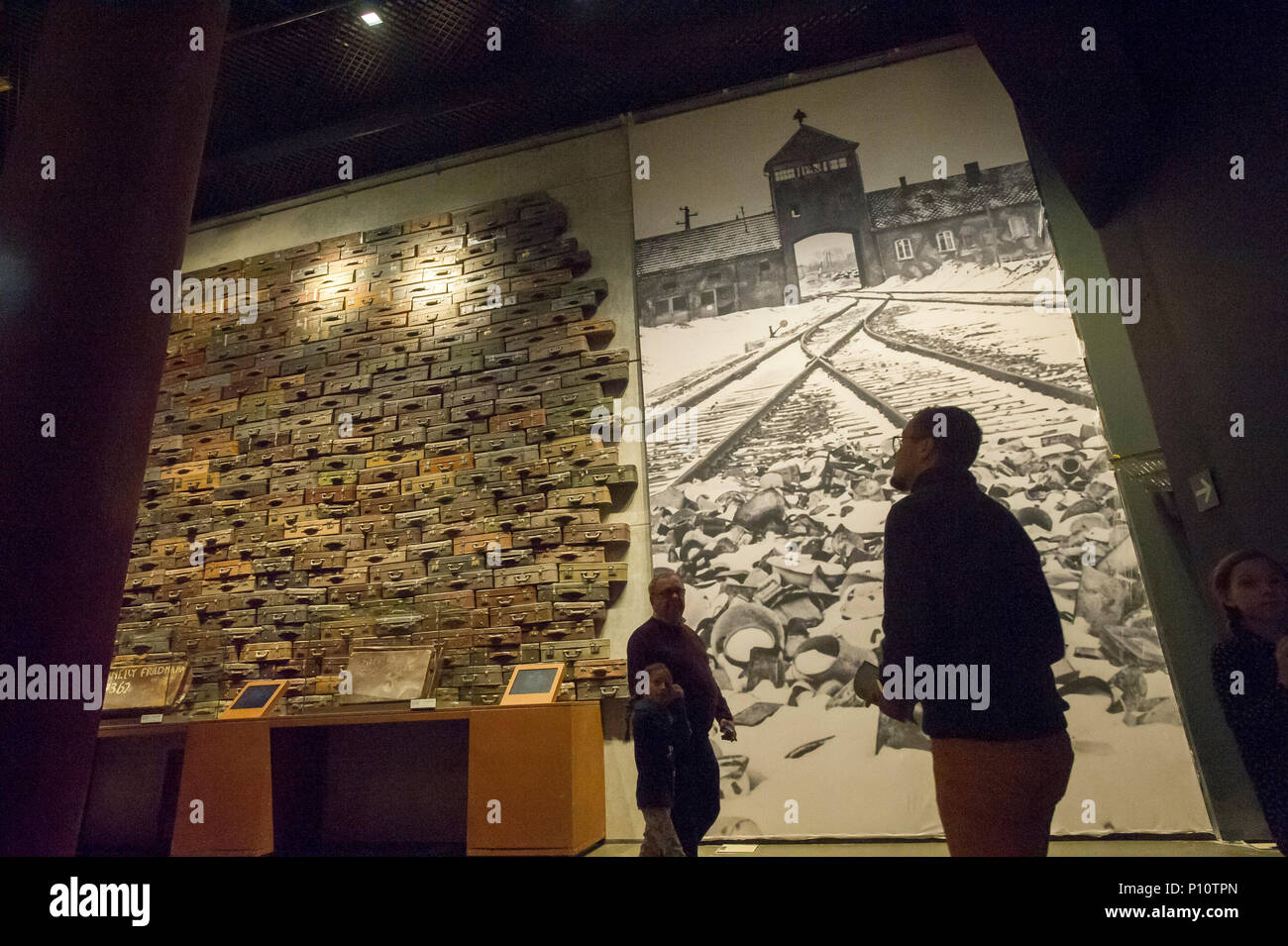 Suitcases of Jewish victims of Holocaust and picture of the main entrance to KL Auschwitz Birkenau as a part of exhibion in Museum of the Second World Stock Photo