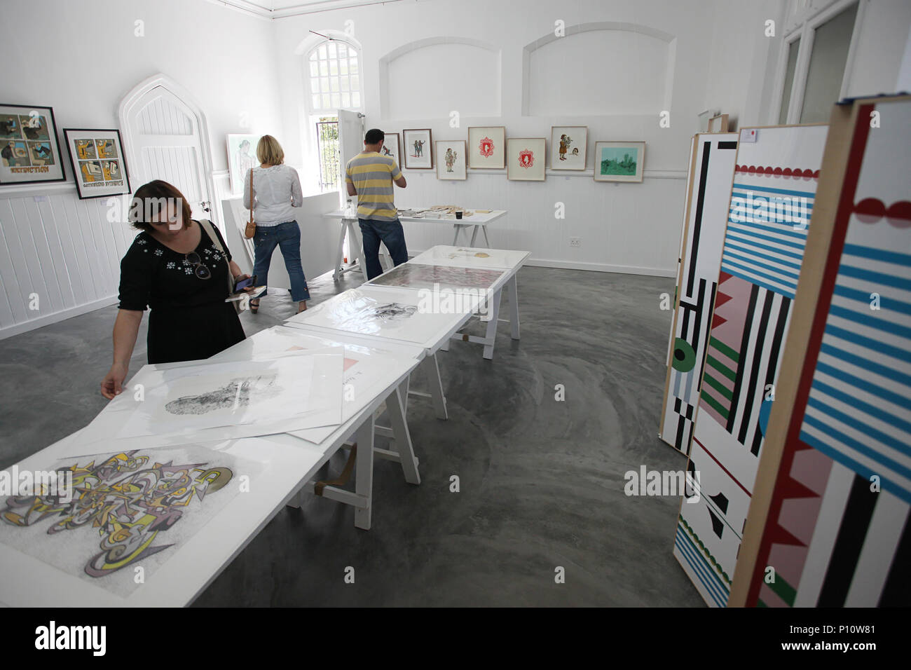 Three people at a Contemporary Art Expo Stock Photo - Alamy