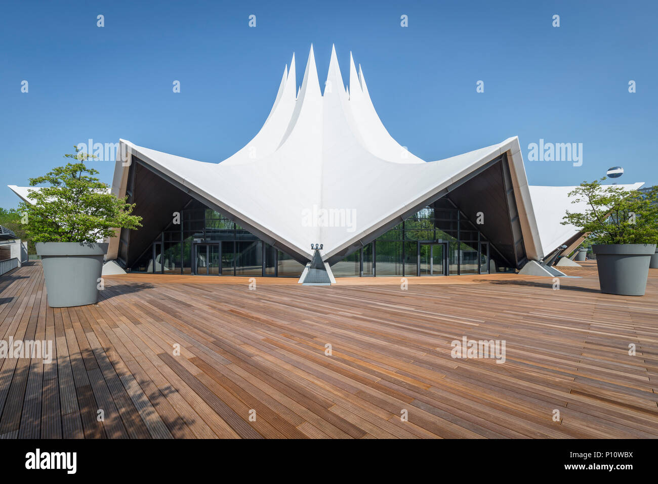 Curved tent-shaped roof shape and wooden-floored terrace of the Tempodrom Concert Hall in Berlin, Germany Stock Photo