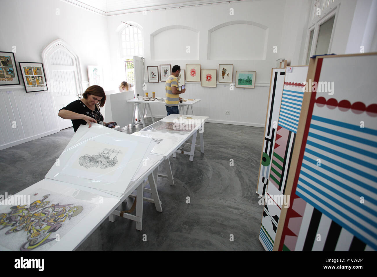 Three people at a Contemporary Art Expo Stock Photo - Alamy