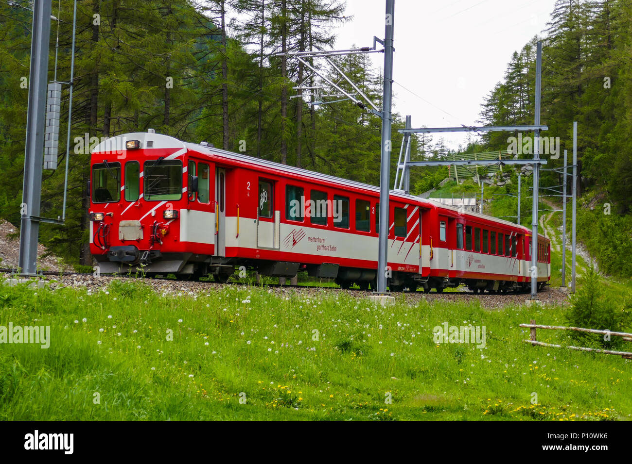 Red electric train running between Tasch and Zermatt, Mattertal, Zermatt,  Switzerland, Alps, Alpine Stock Photo - Alamy