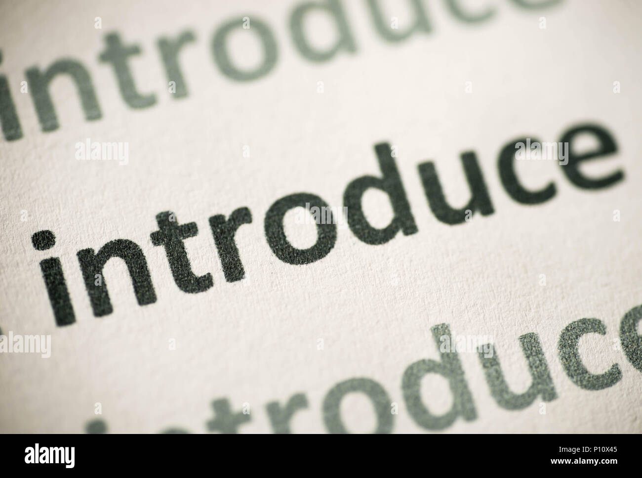 word introduce printed on white paper macro Stock Photo