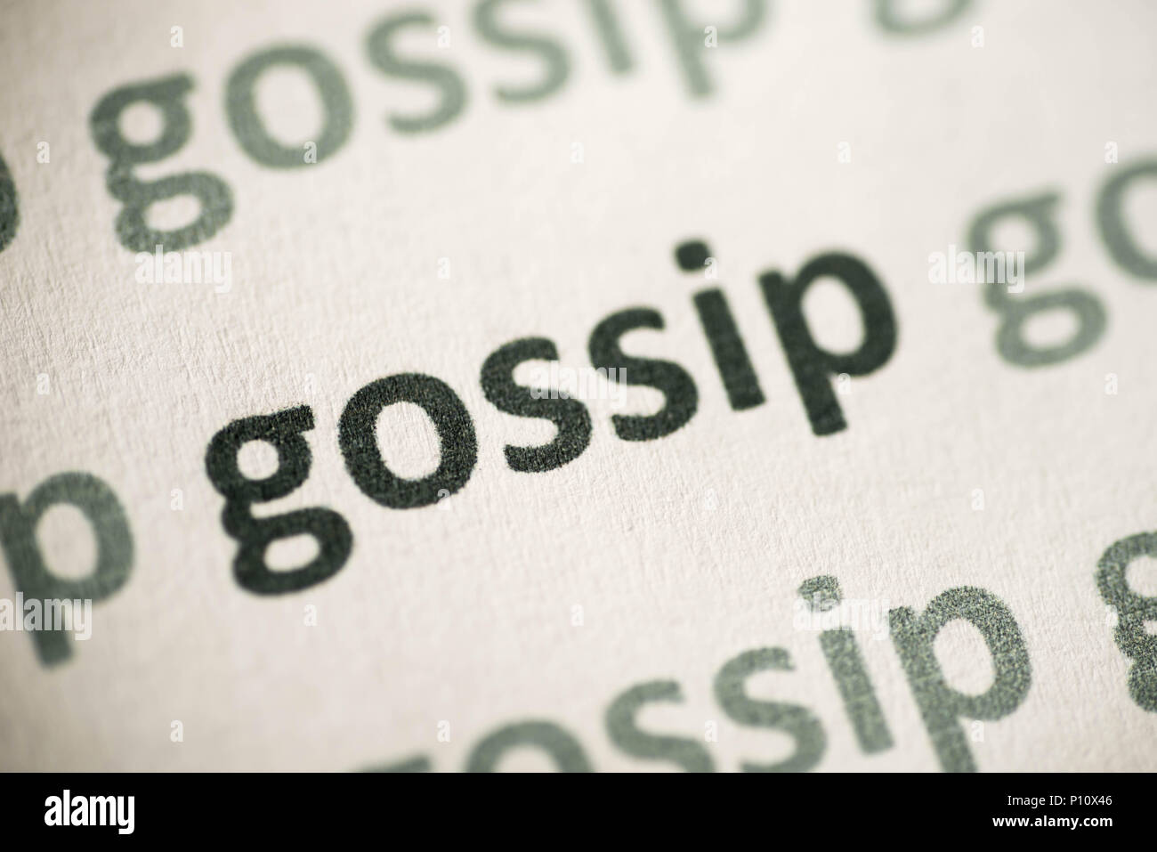 word gossip printed on white paper macro Stock Photo