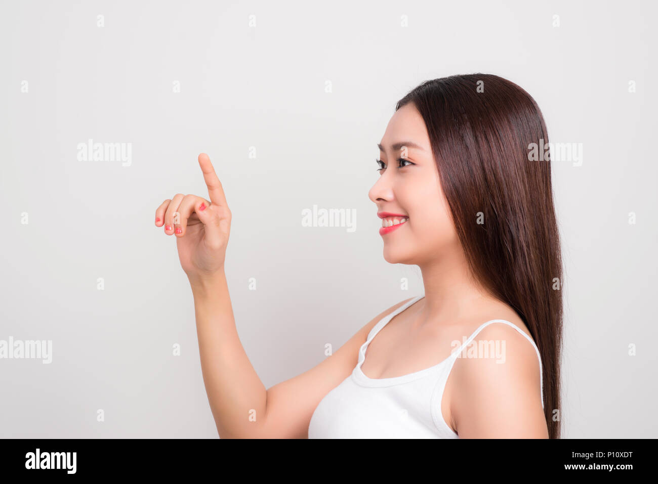 Beauty Woman with perfect makeup Portrait. Touching screen. Gestures for advertisemen Stock Photo