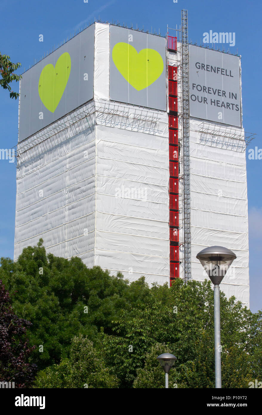 Grenfell Tower where at least 72 people died after a fire broke out on June 14th 2017 in North Kensington with the slogan 'Forever in our Hearts'. Stock Photo