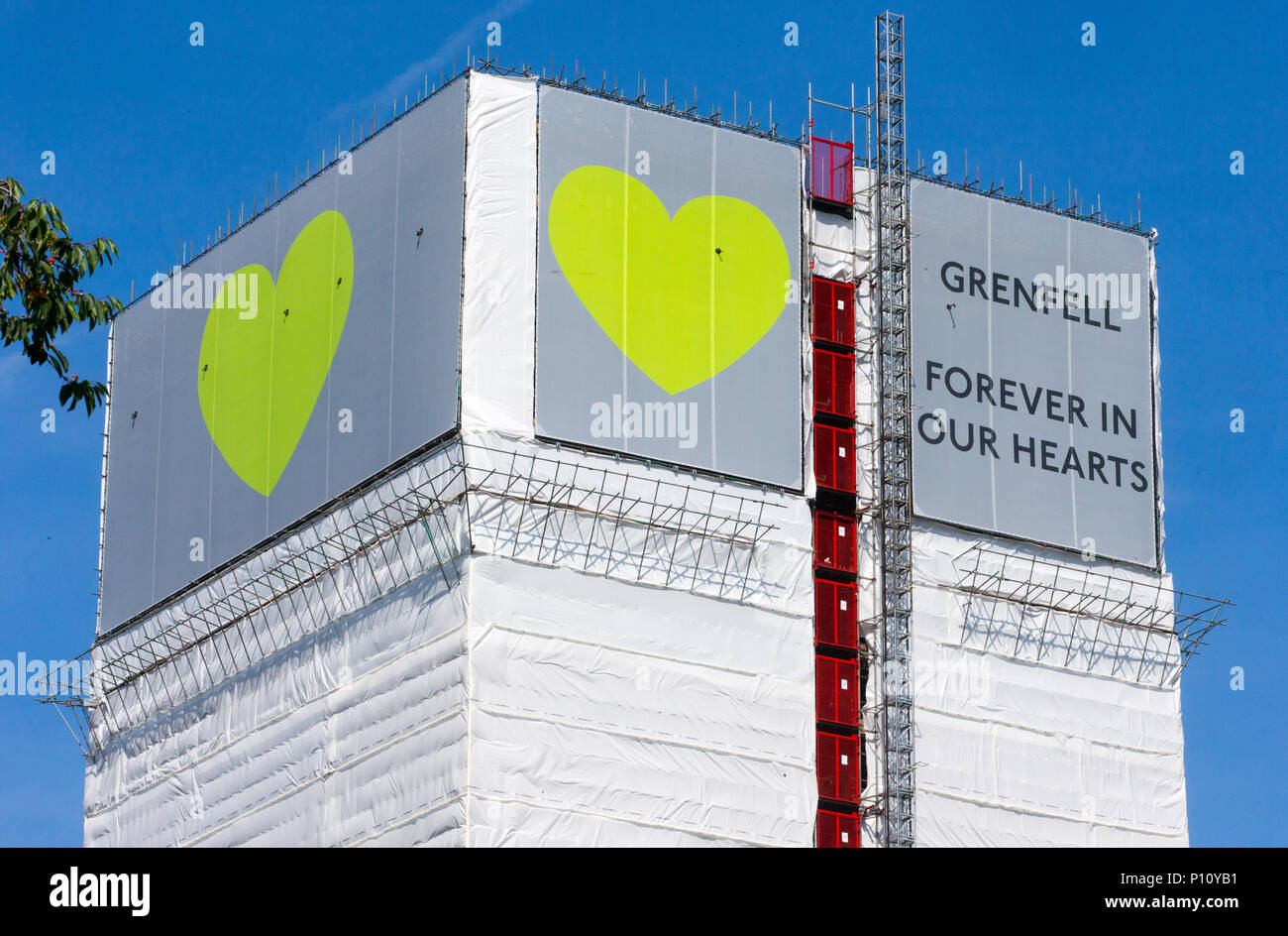 Grenfell Tower where at least 72 people died after a fire broke out on June 14th 2017 in North Kensington with the slogan 'Forever in our Hearts'. Stock Photo