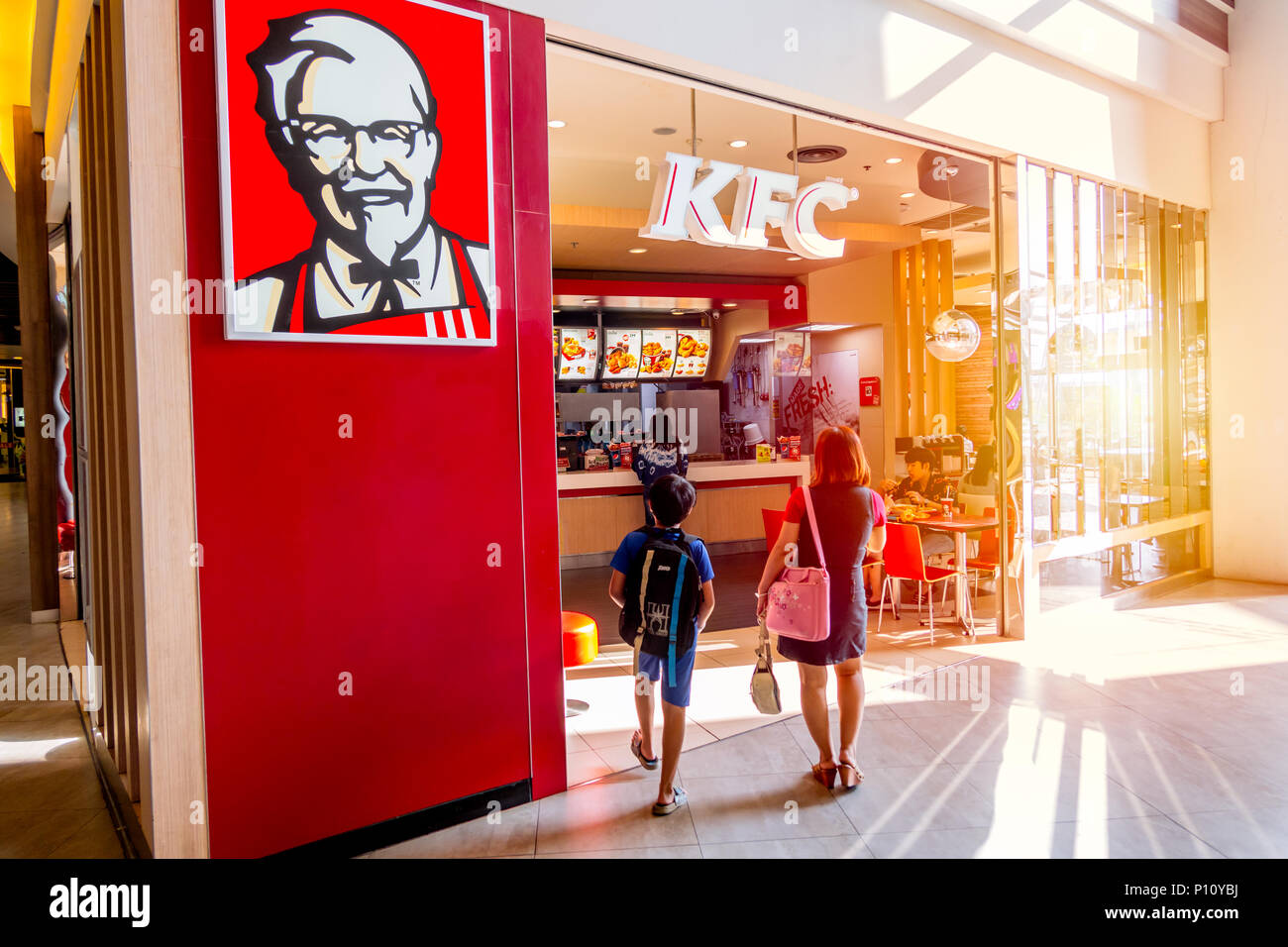 KFC (Kentucky Fried Chicken) shop in super market most popular fast food restaurant and a favorite of parents and kids for family eating together time Stock Photo