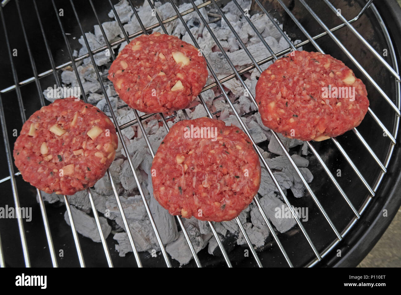 Dangers of food poisoning from summer BBQ meat, Sausages, beef burgers, Kebabs, under-cooked or raw Stock Photo