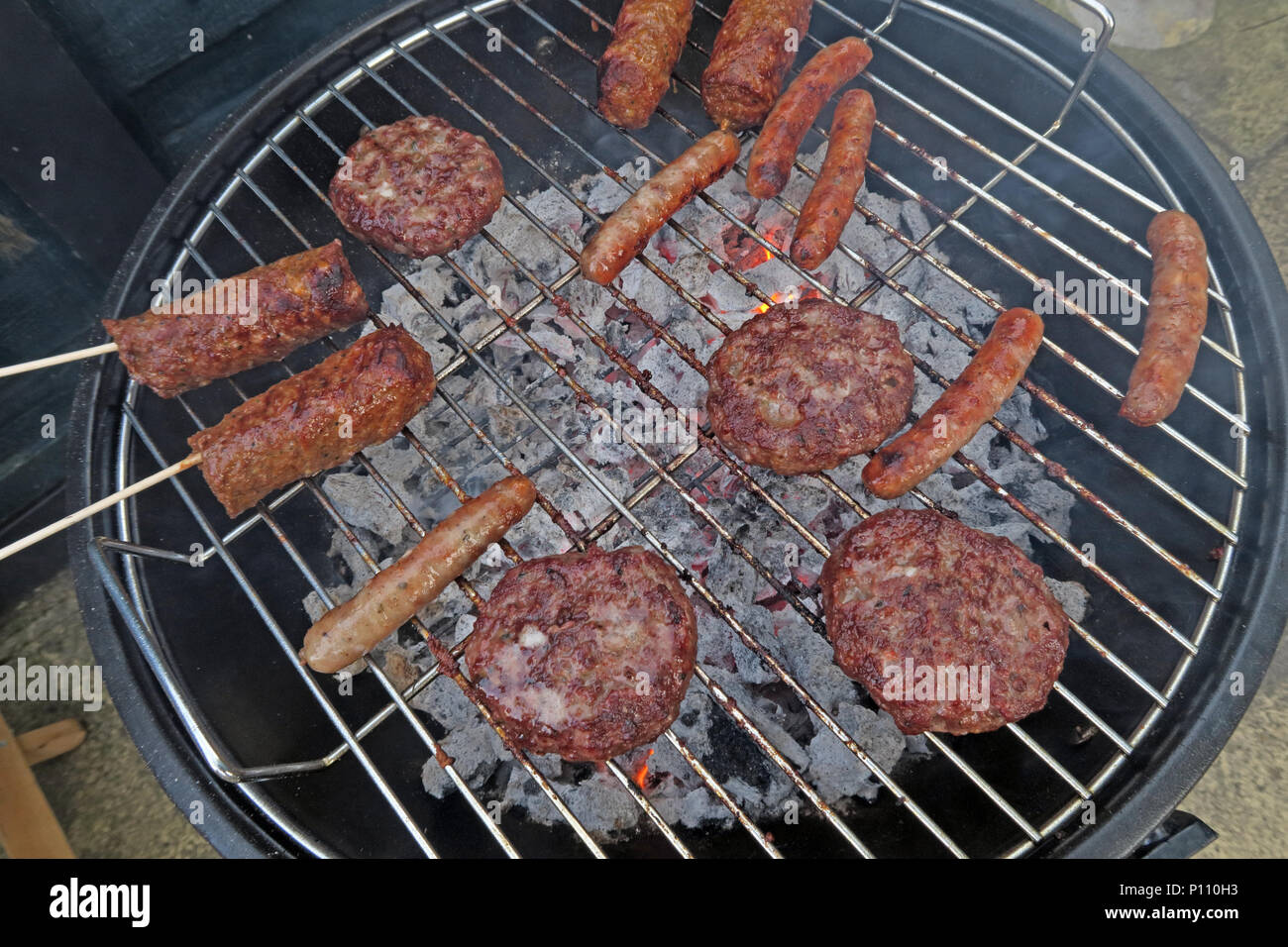 Well cooked BBQ meat on summer garden barbecue Stock Photo