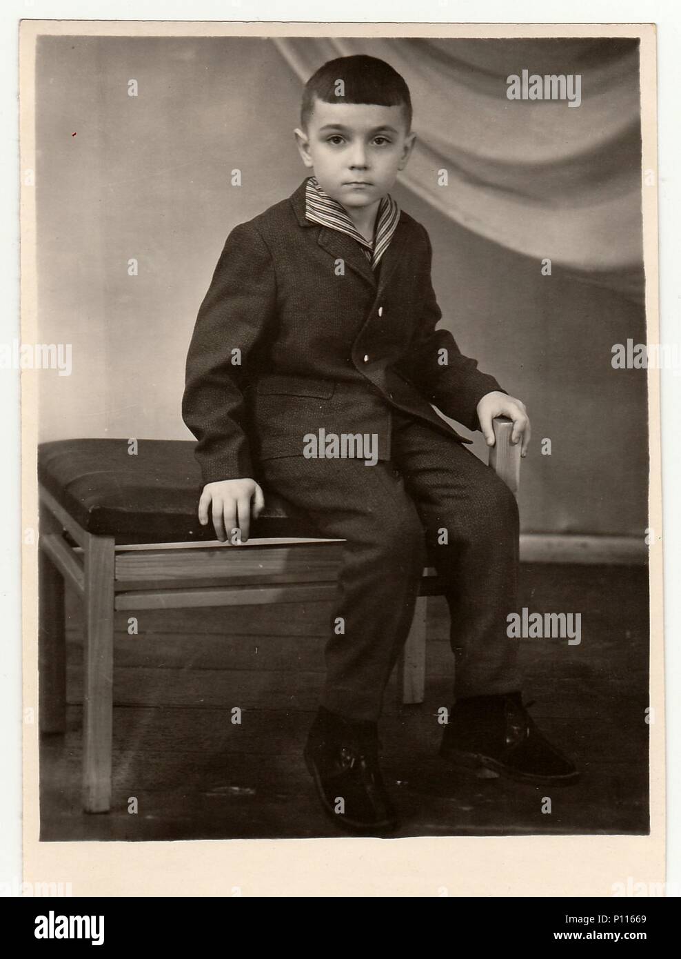 TYUMEN, USSR - CIRCA 1950s: Vintage studio photo shows a small boy. Stock Photo
