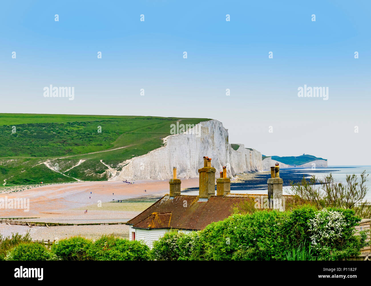 coastguard cottages at seaford head with a view of the seven sisters cliffs in the background Stock Photo