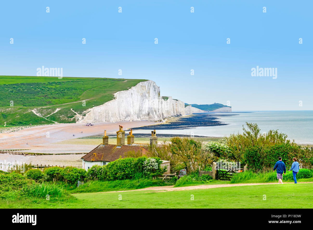 coastguard cottages at seaford head with a view of the seven sisters cliffs in the background Stock Photo