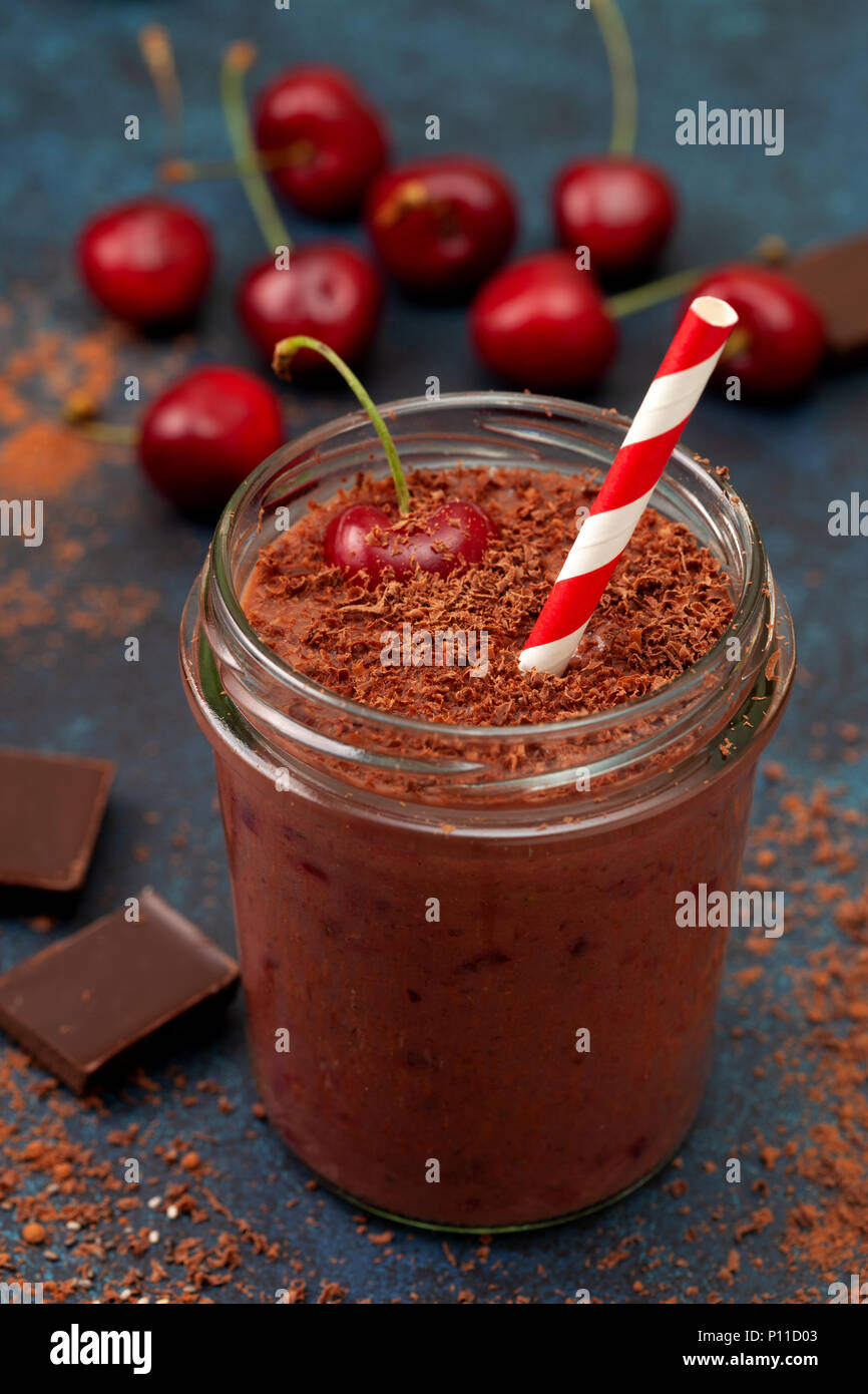 cherry chocolate smoothie (black forest) in a jar on a dark blue