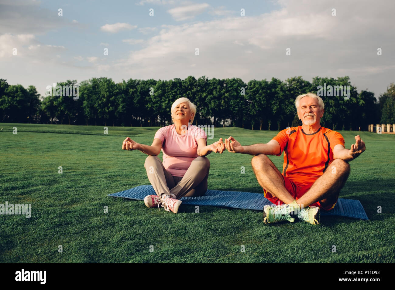 senior couple doing yoga together outdoors Stock Photo