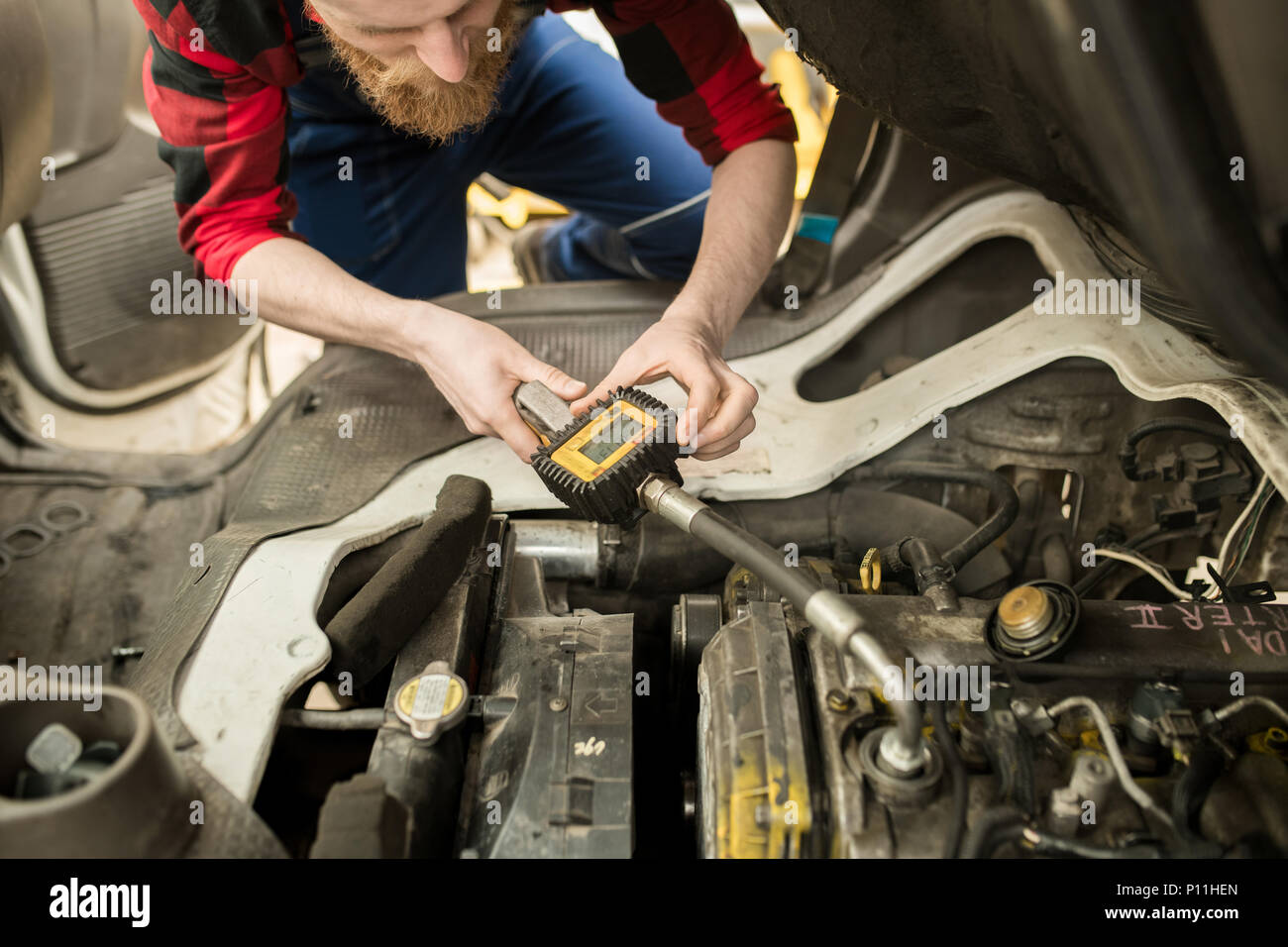 Auto Technician Checking Oil Level Stock Photo Alamy