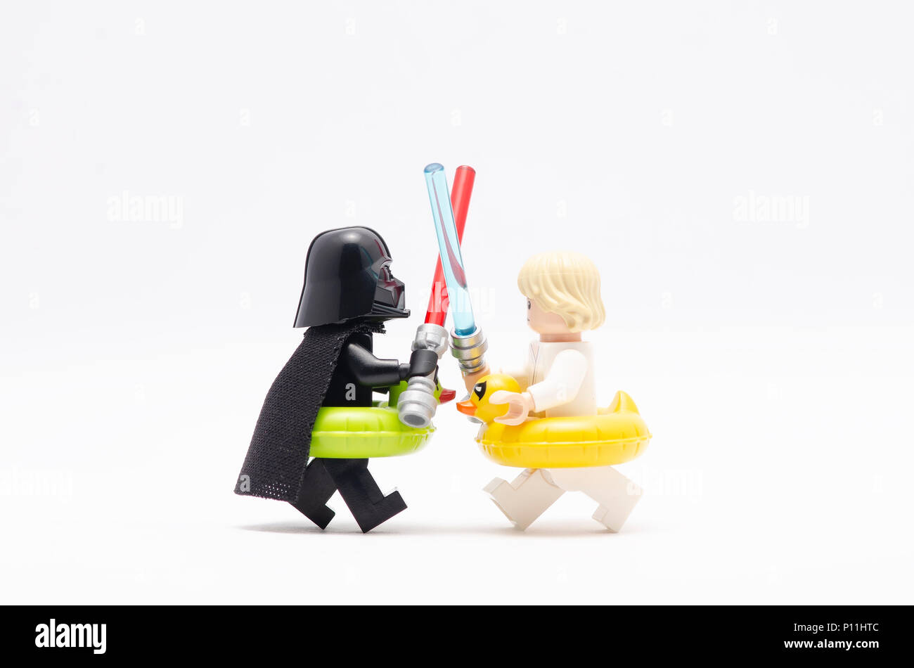 mini figure of darth vader and luke skywalker fighting , wearing floating  duck. Lego minifigures are manufactured by The Lego Group Stock Photo -  Alamy