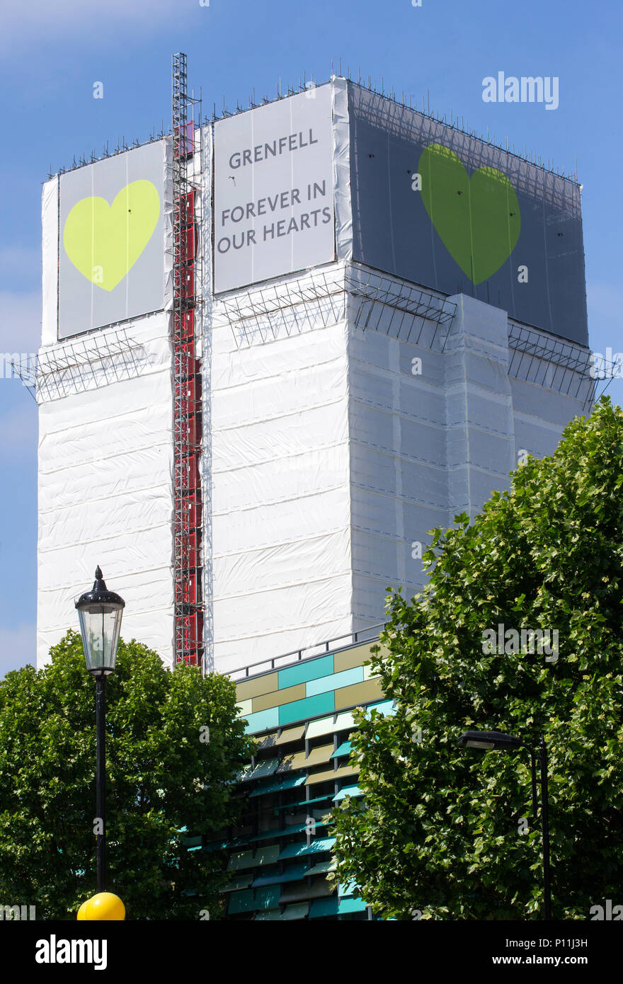 Grenfell Tower where at least 72 people died after a fire broke out on June 14th 2017 in North Kensington with the slogan 'Forever in our Hearts'. Stock Photo