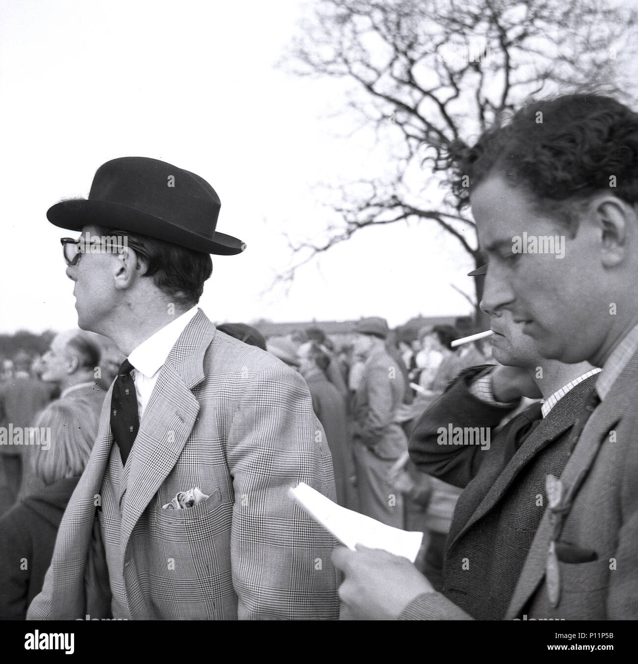 1958, May, well-dressed male race goers outside at a point-to-point amateur horse race meeting at Penshurst, Edenbridge, England, UK. Stock Photo