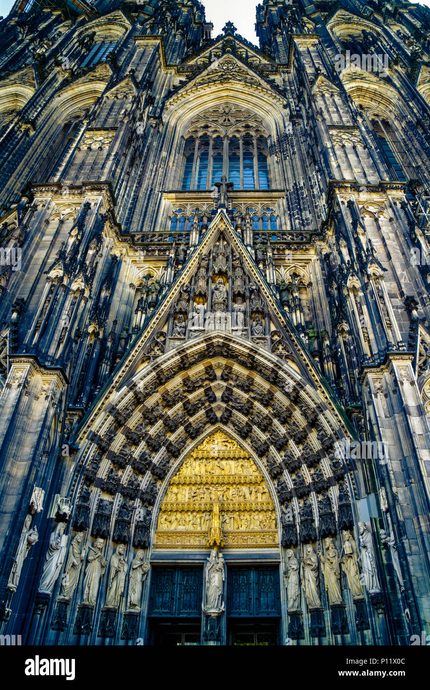 The center main portal of Cologne cathedral is the only one, which has not a special name. It is 9.3 metres wide and, including its gable, more than 28 metres high. The theme of the centre portal is the age before redemption. The trumeau figure in the main portal is Mary, the link between the Old and New Testaments. She is flanked by Peter, the saint to whom the cathedral is dedicated, and the Magi, whose precious relics are venerated in the cathedral. Stock Photo